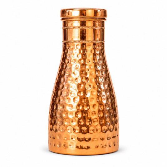 Copper water bottle with a textured surface on a white background
