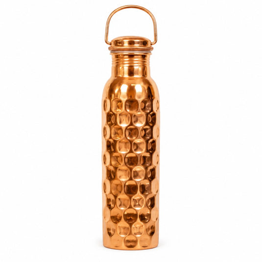 Copper water bottle with a textured surface on a white background